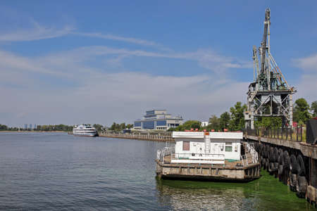 KAZAN, RUSSIA - AUGUST 7, 2021. View of the Kazan river port on the Volga river. Portal crane on the...