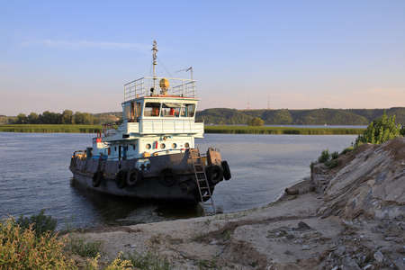 Fishing ship moored to the wild bank of the Volga near the city of Kazan on a sunny summer day. Republic Tatarstan, Russia.の写真素材