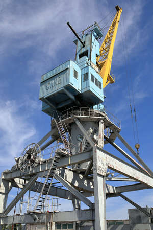 KAZAN, RUSSIA - AUGUST 7, 2021. Portal crane against the blue sky background in the river port of...