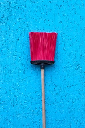 broomstick on the background of blue wall