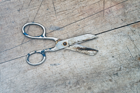 obsolete scissors on a wooden background, retro filter