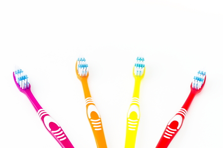 four colored toothbrushes on a white backgroundの写真素材