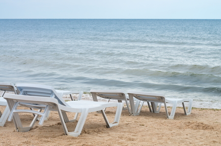 empty beach loungers on the sea beach, bad weather.の写真素材