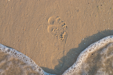 footprint on the sand, beach, sea waveの写真素材