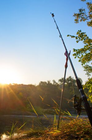 fishing rod on a stand by the riverの写真素材