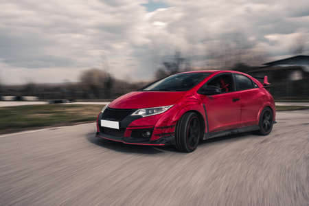 A red sport sedan on the road
