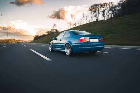 Blue sedan with red xenon lightsの写真素材