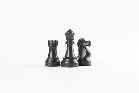 Black rook, queen and knight on white backgroundの写真素材