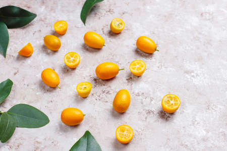 Flat lay of kumquats on a concrete background. Top view