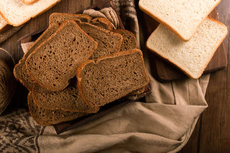 Slices of brown bread in box and white bread