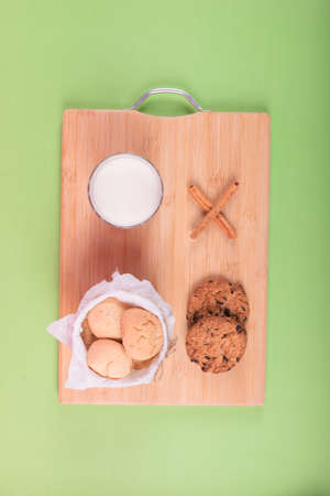 Cup of milk with jar of biscuits