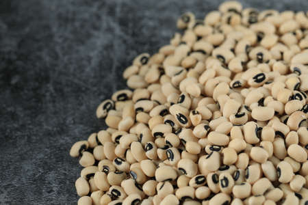 White dry beans spread over the right side of the table