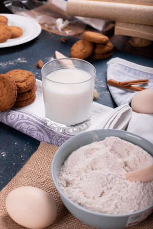 Cup of milk with jar of biscuits