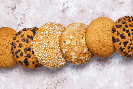 Set of various american style cookies on a light concrete background. Shortbread with confetti,...