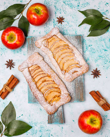 Homemade organic apple puff pastry pies with apples ready to eat,top viewの写真素材