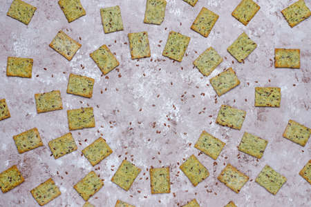 Crackers with olive oil,linen seeds and greens,top viewの写真素材