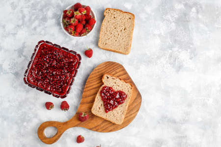homemade raspberry jam with fresh raspberries on concrete background,top viewの写真素材