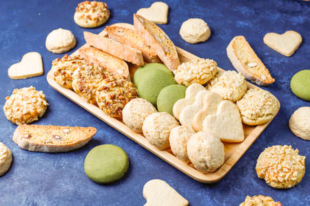 Various nut cookies walnut cookies,peanut cookies,almond cookies and matcha cookies on light background,top viewの写真素材