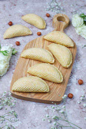 Azerbaijan national pastry shakarbura on white plate on grey concrete background ,top view,spring...