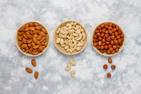 Assortment of nuts in ceramic plates.の写真素材