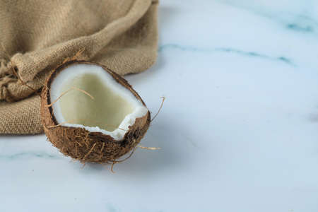 Coconut fruit on a blue marble with burlap