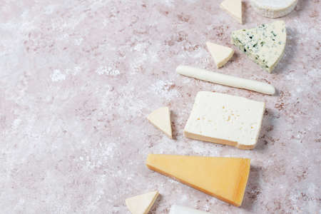 Various types of cheese on light brown background,top viewの写真素材