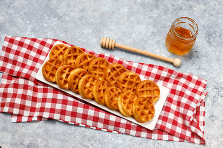 Homemade Mini waffles on grey concrete background