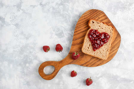 homemade raspberry jam with fresh raspberries on concrete background,top viewの写真素材