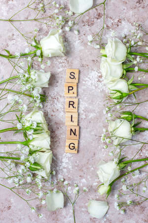 Spring card with white roses and flowers on light background,top viewの写真素材