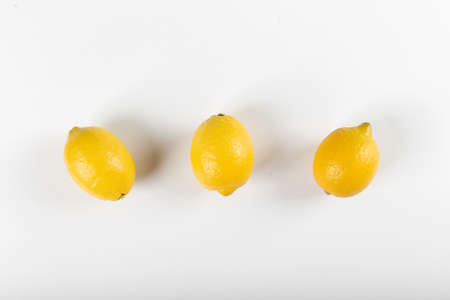 Lemons in a row isolated on white. top viewの写真素材