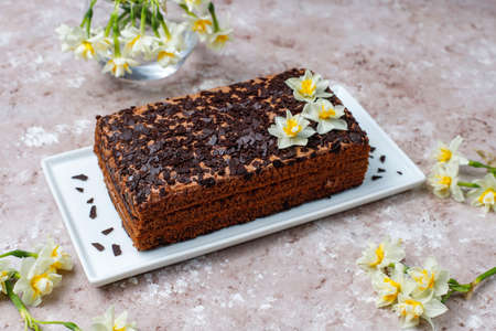 Tasty homemade chocolate truffle cake with coffee on light background