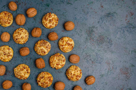 Homemade walnut cookies with walnuts on dark background,top view