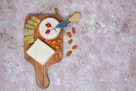 Various types of cheese on light brown background,top viewの写真素材