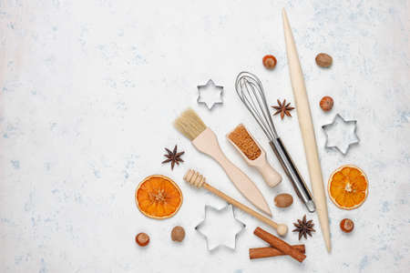 Kitchen baking utensils with spices for cookies and cookie cutters on light backgroundの写真素材