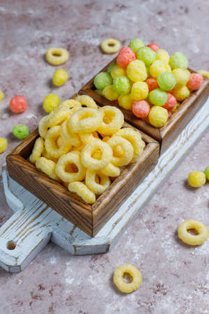 Various corn flakes in wooden boxes on concrete background