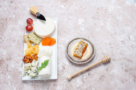 Various types of cheese on light brown background,top viewの写真素材