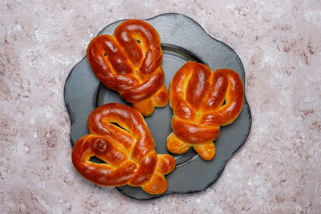 Various sweet buns on brown concrete background,top view