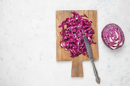 Process of cooking slicing food fresh vitamin salad from red cabbage on cutting board,top view
