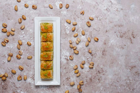 Traditional Turkish Pastry Dessert Baklava with pistachio nuts on concrete background.の写真素材