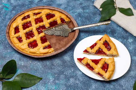 Delicious traditional berry cherry pie Crostata on grey dark backgroundの写真素材