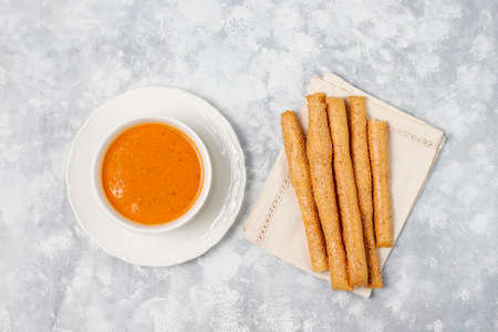 Red lentil cream soup on light background in white bowl,top viewの写真素材