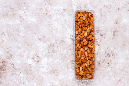 Beech nuts on light background,top view