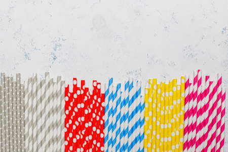 Paper straws of different colors on light background with copy spaceの写真素材
