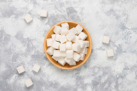 White sugar cubes on concrete background,top view