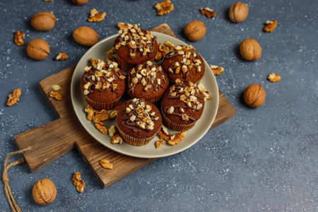 Chocolate-walnut muffins with coffee cup with walnuts on dark background ,Selective Focus.の写真素材