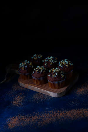 Chocolate-walnut muffins with coffee cup with walnuts on dark background ,Selective Focus.