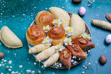 Traditional Azerbaijan holiday Novruz cookies baklavas and shakarburas on black tray plate on dark backgroundの写真素材