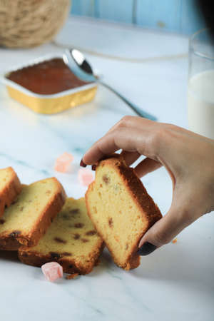Taking Sliced pie with sultana by hand
