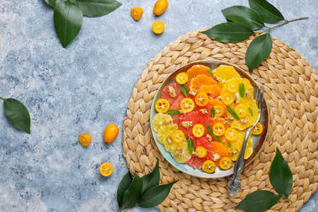 Raw Homemade Citrus Salad with grapefruit,lemon,tangerine,kumquat,oranges,honey,walnut and mint leavesの写真素材