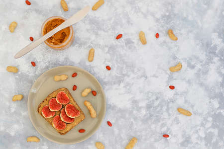 Traditional American and European summer breakfast: sandwiches of toast with peanut butter, berry,peach,fig, strawberry,raspberry, copy space top viewの写真素材